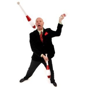 Man juggling in a black suit stock photo