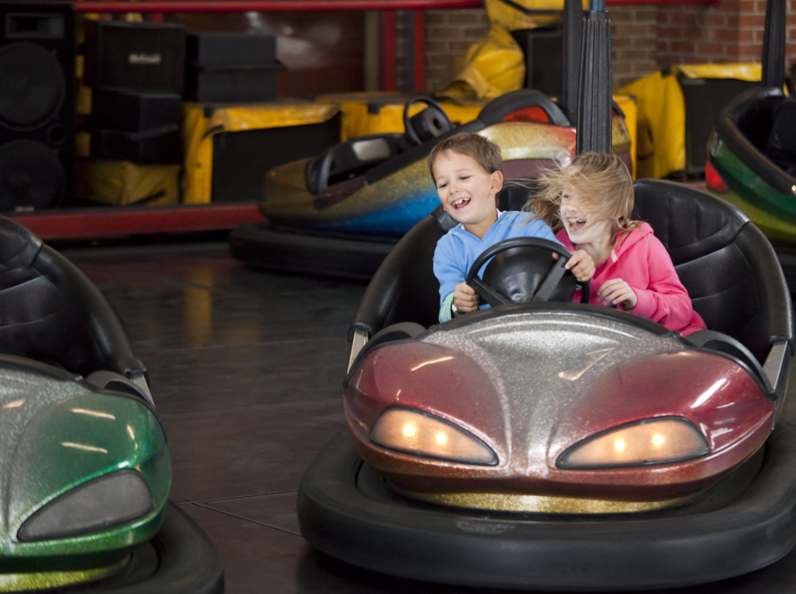 children are having fun in speedy bumper cars