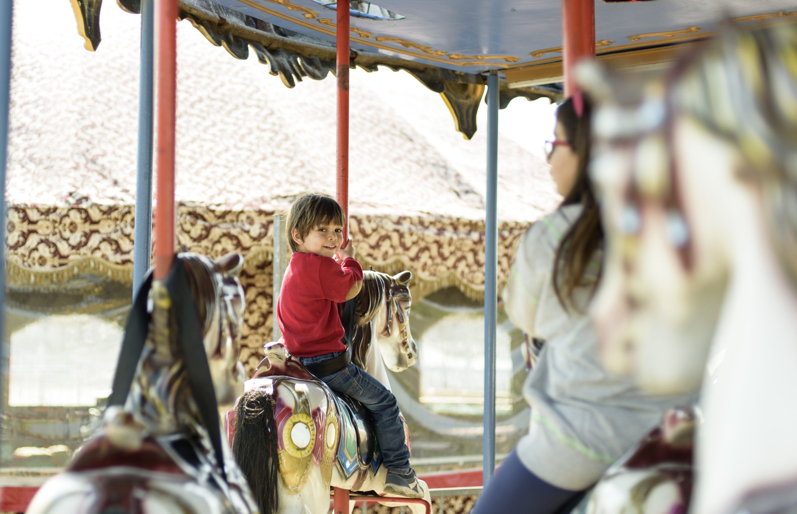 Little boy and girl on carousel