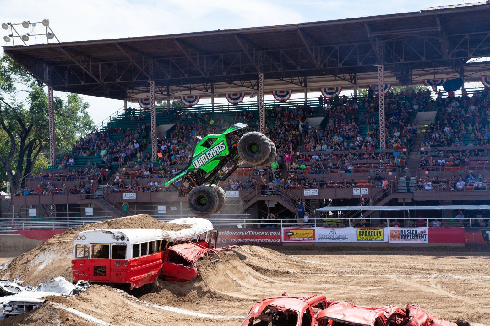 Monster truck leaping off a bus at the Colorado State Fair Monster Truck Show