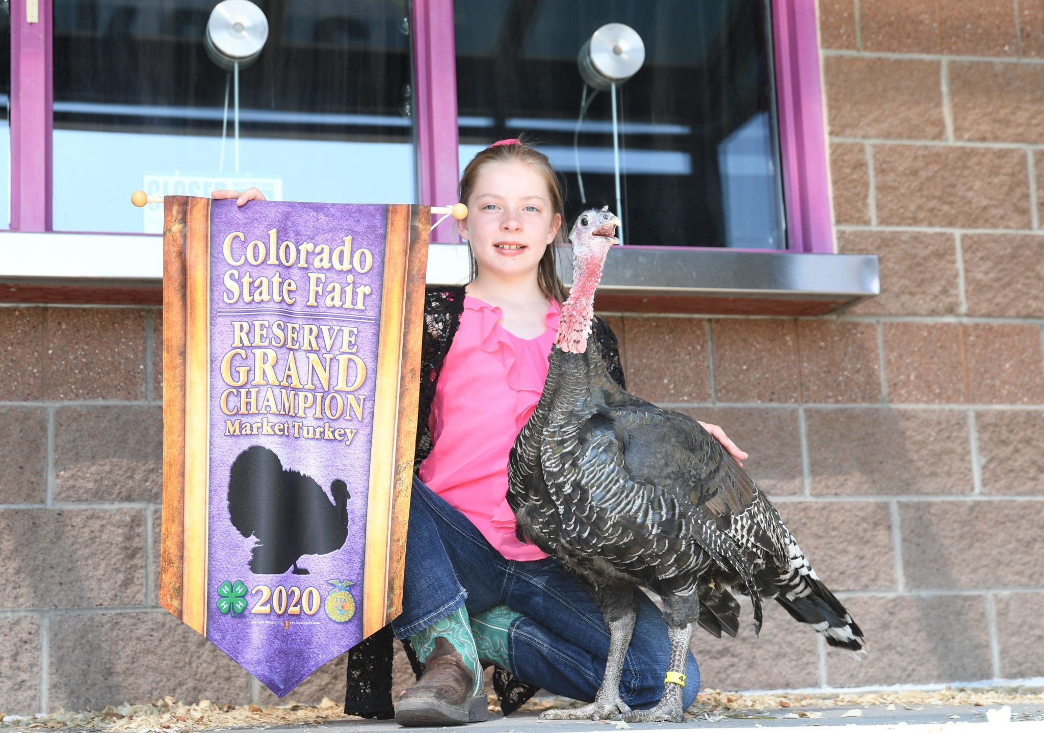 young girl holding her award for a turkey she raised