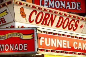 Signs for carnival foods during a staycation at the Colorado State Fair