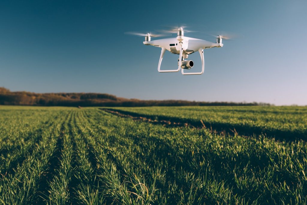 A drone flies over a farm field