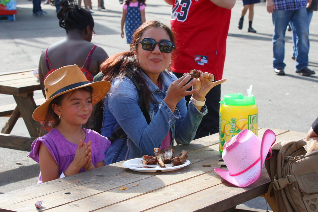 A family sits at the Colorado State Fair enjoying a tasty snack