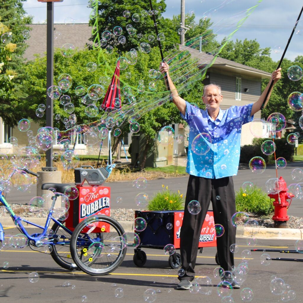 Man standing with bubbles blowing around