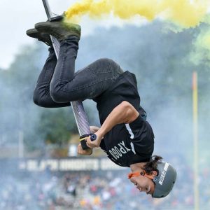 man upside down on pogo stick